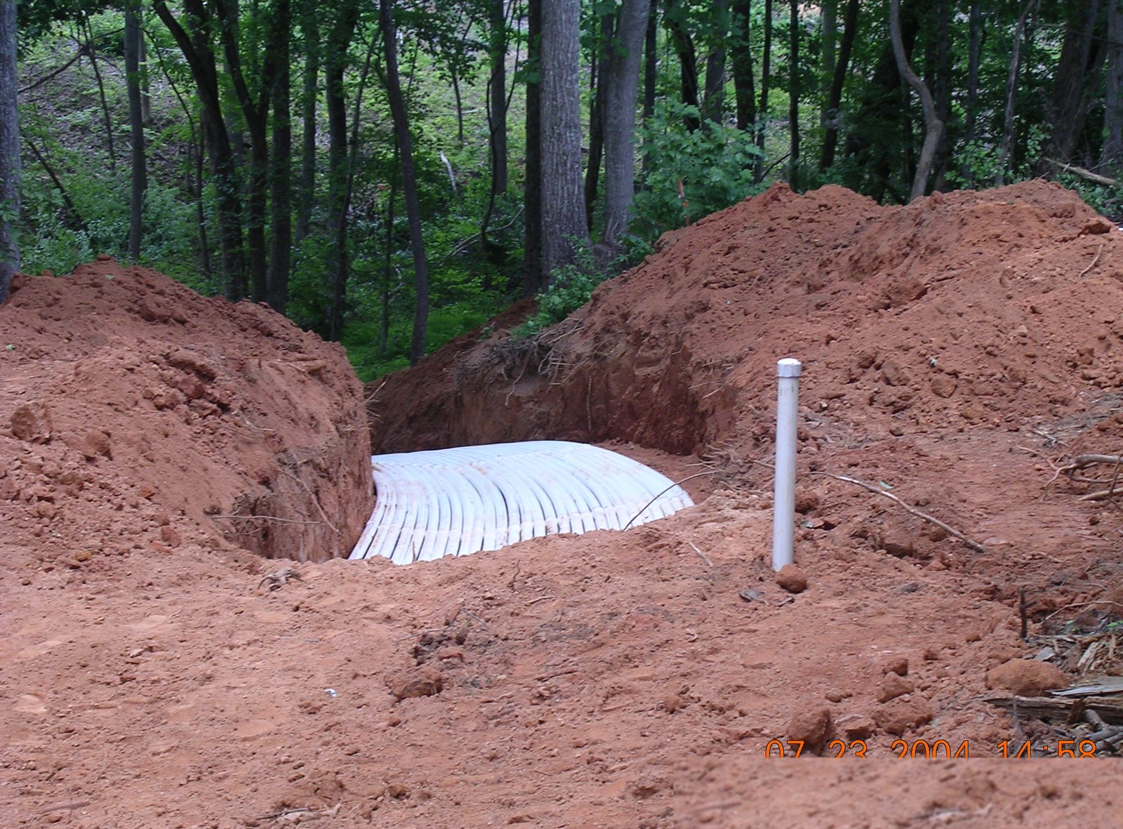 Septic system drain field installation at a rural Craighead County property